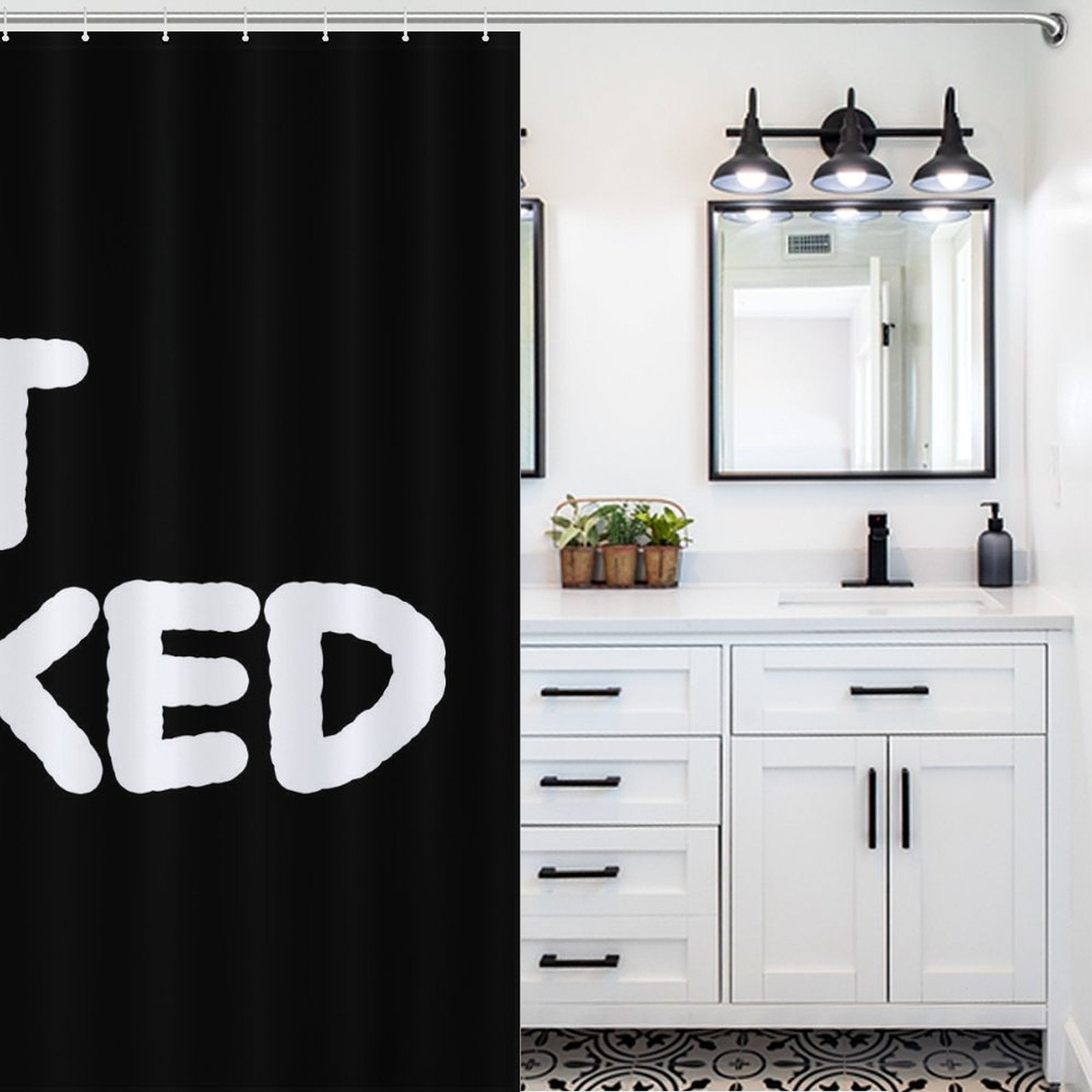A bathroom with a Cotton Cat Funny Black and White Letters Get Naked Shower Curtain-Cottoncat, a white vanity with drawers, double sinks, and mirrors with sconce lighting. The floor has a striking black and white pattern.