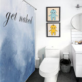 A bathroom with a toilet, sink, round mirror, and a Funny Letters Abstract Blue Get Naked Shower Curtain-Cottoncat that adds a touch of humor. Two framed pictures of cartoon characters hang on the wall above the toilet.