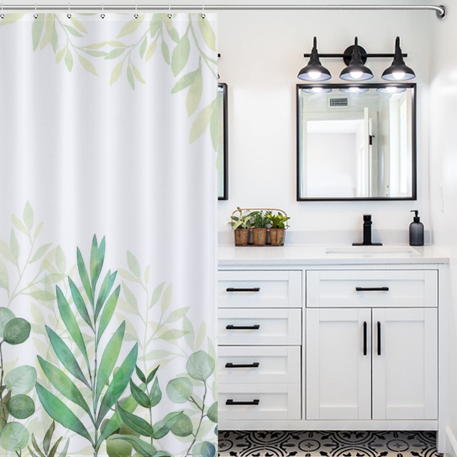 Modern bathroom with a Cotton Cat Natural Modern Ombre Sage Green White Leaf Shower Curtain-Cottoncat, black and white cabinets with black handles, a mirror above the sink, and light fixtures with three bulbs on the wall. Natural tones are emphasized by a plant on the counter.