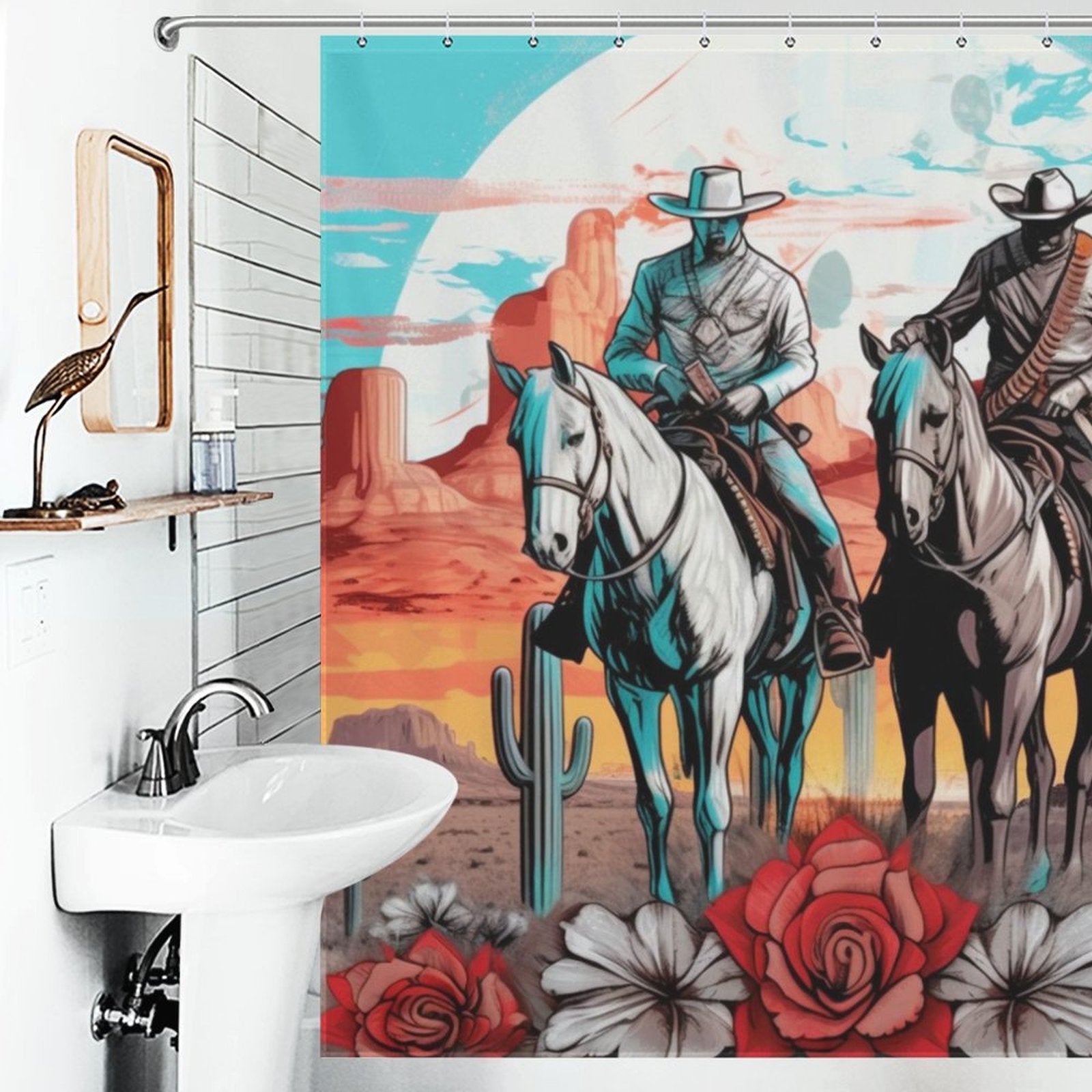 A Western-themed bathroom features a sink, a wall mirror, and a colorful Cowboy Riding Horses Western Shower Curtain-Cottoncat by Cotton Cat depicting two cowboys on horses with a desert landscape, cacti, and large flowers in the foreground.