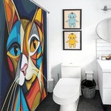 A bathroom featuring a Cotton Cat Abstract Geometric Vintage Colorful Modern Art Minimalist Mid Century Cat Shower Curtain-Cottoncat, two framed cartoon character prints, a toilet, black trash bin, sink, and mirror with subtle touches of modern art.