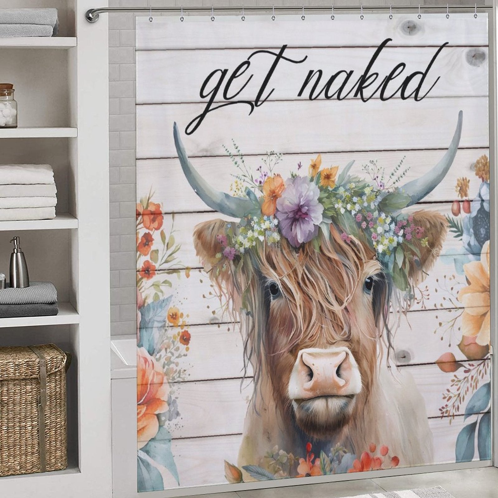 The Funny Letters Get Naked Flower Highland Cow Shower Curtain-Cottoncat by Cotton Cat features an image of a Highland cow wearing a floral crown, coupled with the cheeky text "get naked" at the top. The backdrop showcases a wooden plank design adorned with additional floral decorations, adding a rustic charm to your bathroom.