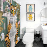 A unique bathroom decor includes a Funny Cool Tiger Reading Shower Curtain-Cottoncat by Cotton Cat depicting a reading tiger, two framed character illustrations on the wall, a toilet, a wastebasket, a sink with a mirror, and various toiletries.