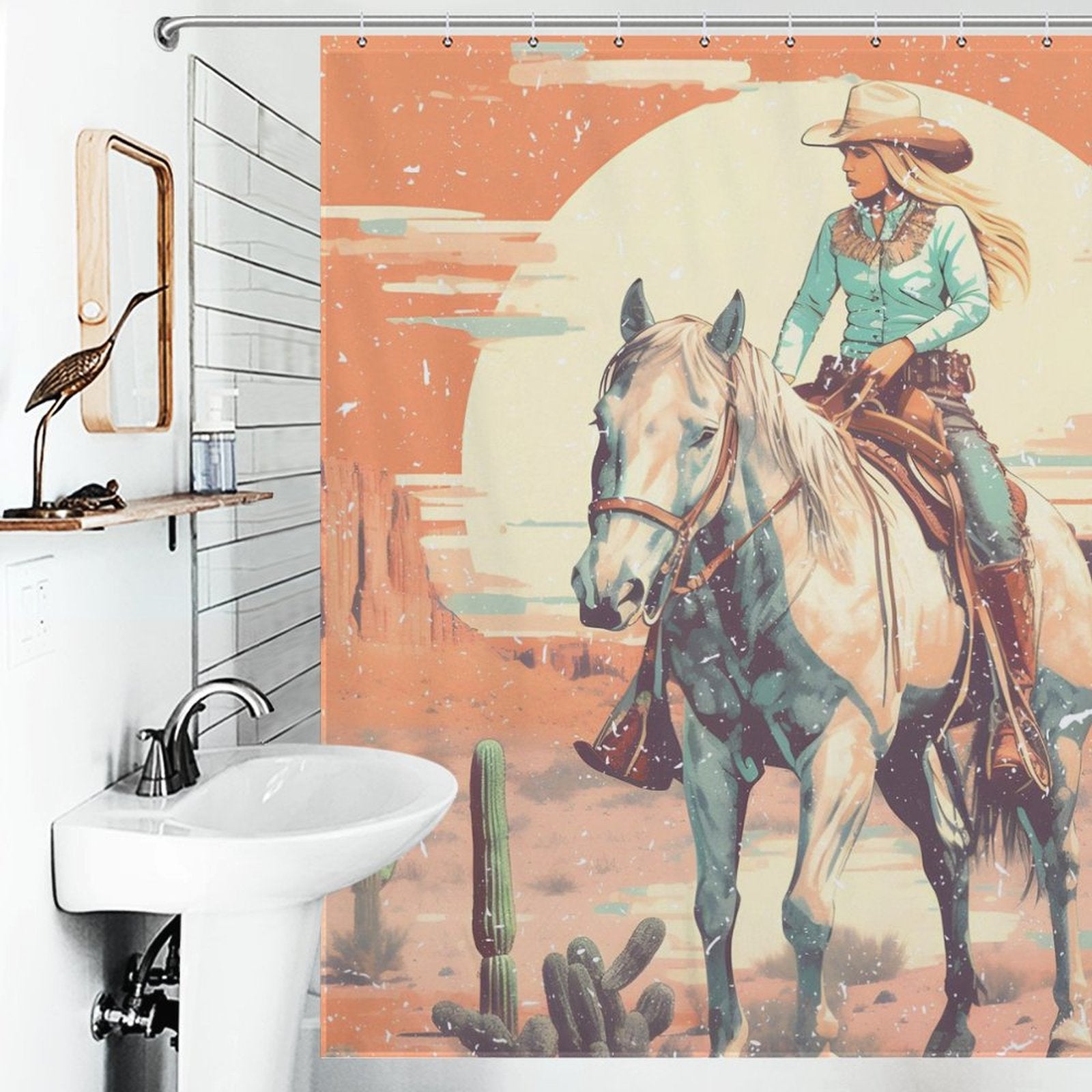 A bathroom with a Rustic Sunrise Western Cowgirl Shower Curtain-Cottoncat by Cotton Cat, featuring a Western Cowgirl on a horse in a desert setting, complemented by cacti and a large, rustic sunrise in the background.