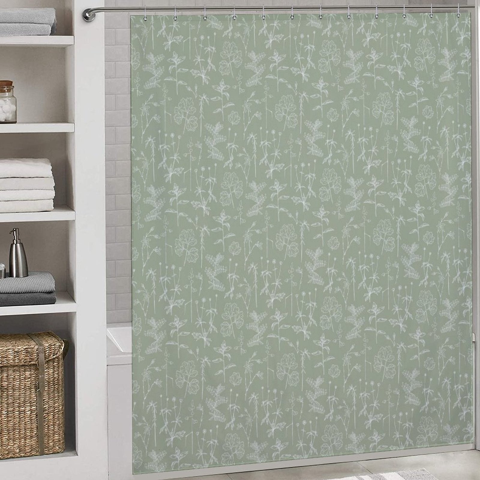 A bathroom with a Boho Retro Sage Green Herbs Flower Shower Curtain-Cottoncat by Cotton Cat, a white shelving unit holding folded towels, a basket, and various toiletries.