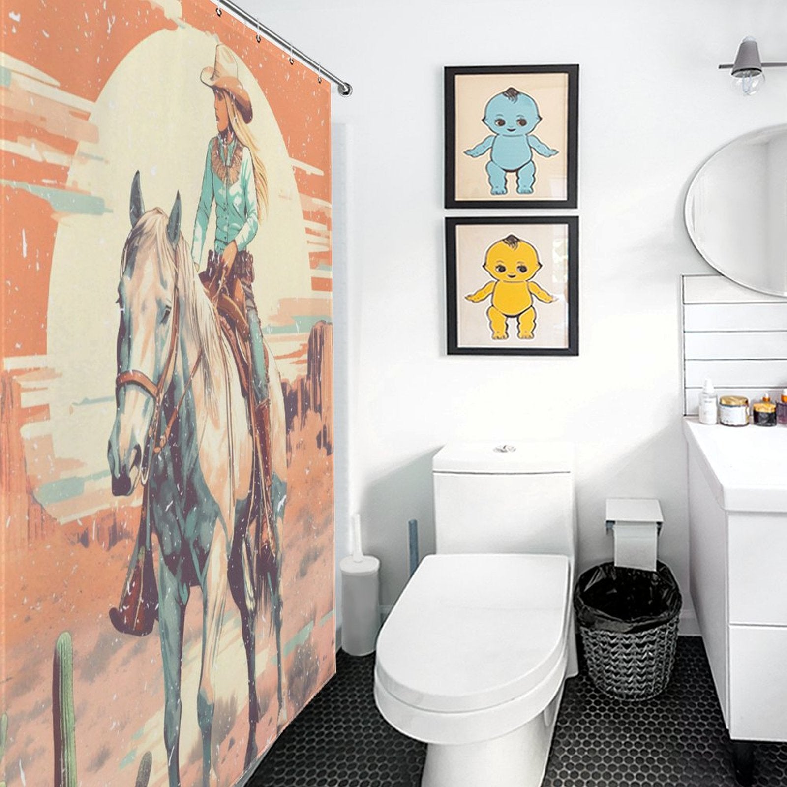 A bathroom with a Rustic Sunrise Western Cowgirl Shower Curtain-Cottoncat by Cotton Cat featuring a rider on horseback, two framed prints of cartoon characters on the wall, a toilet, a sink with mirror, and a trash can.