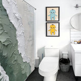 A bathroom with a white toilet, a white sink, and a black trashcan. Two framed pictures of cartoon characters adorn the wall, while a Coastal Oil Painting Ocean Sea Green Waves Minimalist Shower Curtain Abstract Beach Shower Curtain-Cottoncat by Cotton Cat features an abstract design reminiscent of ocean sea green waves.