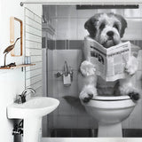 A dog is sitting on a toilet in a bathroom, holding and reading a newspaper. There is a sink and decorative crane on the wall in the foreground, complemented by a Black and White Funny Read Book Dog Shower Curtain-Cottoncat from Cotton Cat that adds an extra touch of humor to the scene.