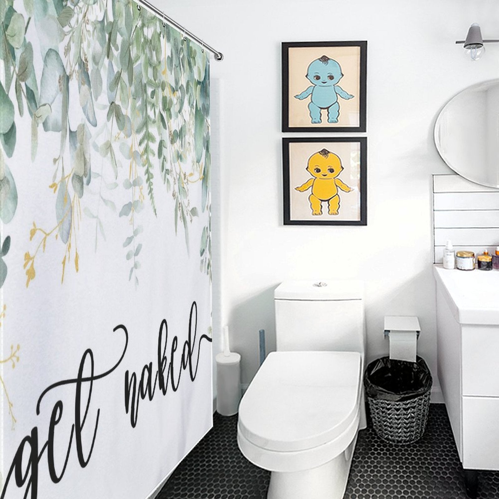 A bathroom with a **Cotton Cat Get Naked Funny Letters Eucalyptus Leaves Print Shower Curtain-Cottoncat** featuring eucalyptus leaves print and "Get Naked" text, alongside a modern toilet, a vanity with a sink, and two framed animal artworks on the wall.