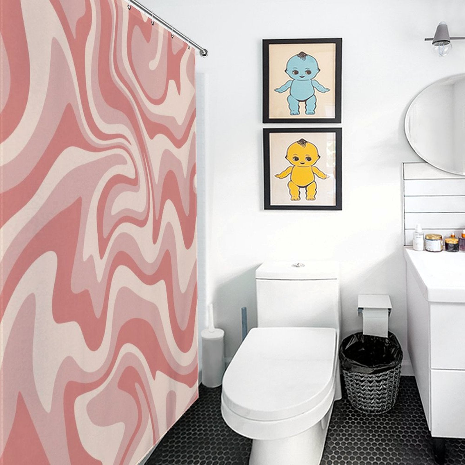 Bathroom with a **Cotton Cat Vintage Modern Wave 70s Cute Wavy Swirl Retro Pink Abstract Shower Curtain-Cottoncat**, a toilet, a round mirror above a sink, and two framed pictures of cartoon characters on the wall.