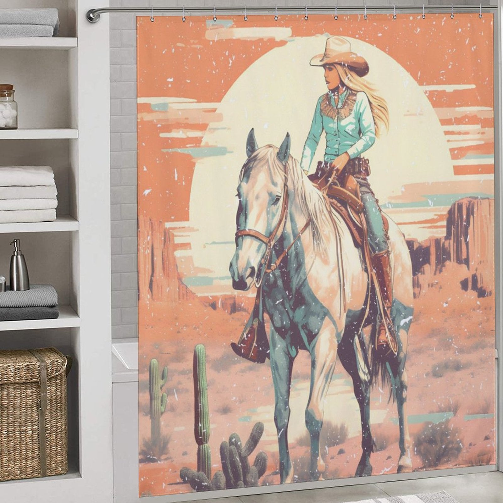 The Cotton Cat Rustic Sunrise Western Cowgirl Shower Curtain with an illustration of a Western cowgirl riding a horse in a desert landscape, featuring cacti and cliffs under a rustic sunrise with a large sun.