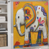 A bathroom featuring a Cute Baby Elephant Shower Curtain-Cottoncat by Cotton Cat as the focal point. The surrounding area has shelves with white towels and a wicker basket for storage, enhancing the charming bathroom decor.