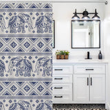 A blue and white bathroom with a Cotton Cat Ethnic Elephant Shower Curtain featuring an ethnic pattern.