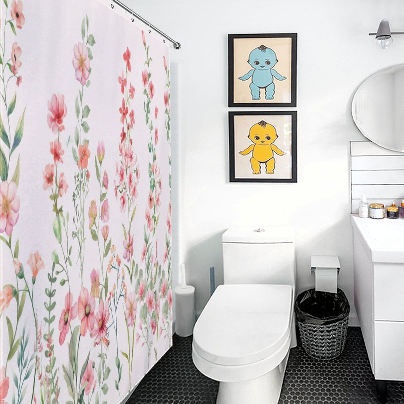 Bathroom with a Rustic Spring Blossom Pink Floral Shower Curtain-Cottoncat, two cartoon character wall artworks, a round mirror, white sink, and toilet on hexagonal black tiles.