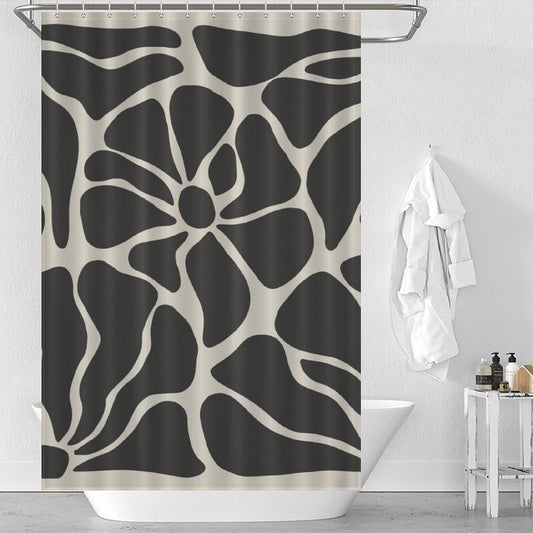 A Vintage Boho Flower Black and Grey Art 70s Black Floral Mid Century Abstract Shower Curtain-Cottoncat by Cotton Cat hangs in a bathroom with a white bathtub, a white bathrobe, and toiletries visible.