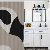 Modern bathroom with a white vanity, black accents, and decorative tile flooring. A Modern Geometric Art Minimalist Curve Beige Black and Grey Abstract Shower Curtain-Cottoncat by Cotton Cat is partially visible on the left. Two rectangular mirrors and black light fixtures are above the vanity.