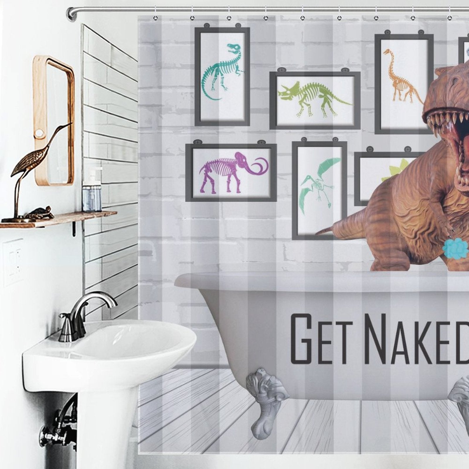 A bathroom with a sink, a framed mirror, and a Funny Dinosaur Get Naked Shower Curtain-Cottoncat displaying "Get Naked." There's also part of a T-Rex model visible on the right side, making this waterproof bathroom decor both amusing and practical.