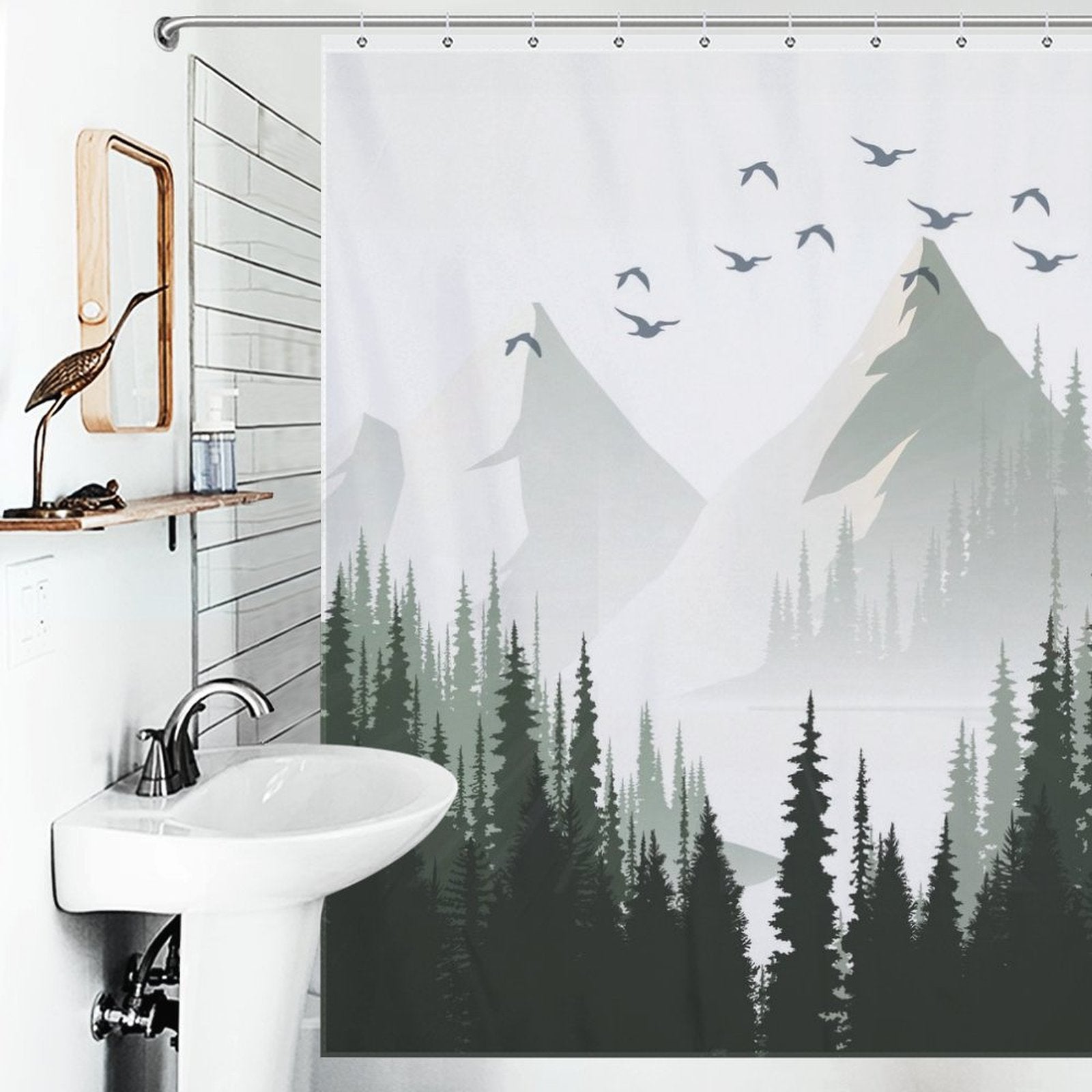 Bathroom with a sink, wall mirror, and a Green Misty Forest Shower Curtain Ombre Sage Green White Nature Tree Mountain Woodland-Cottoncat. The nature scene bathroom decor by Cotton Cat creates a serene and tranquil atmosphere.