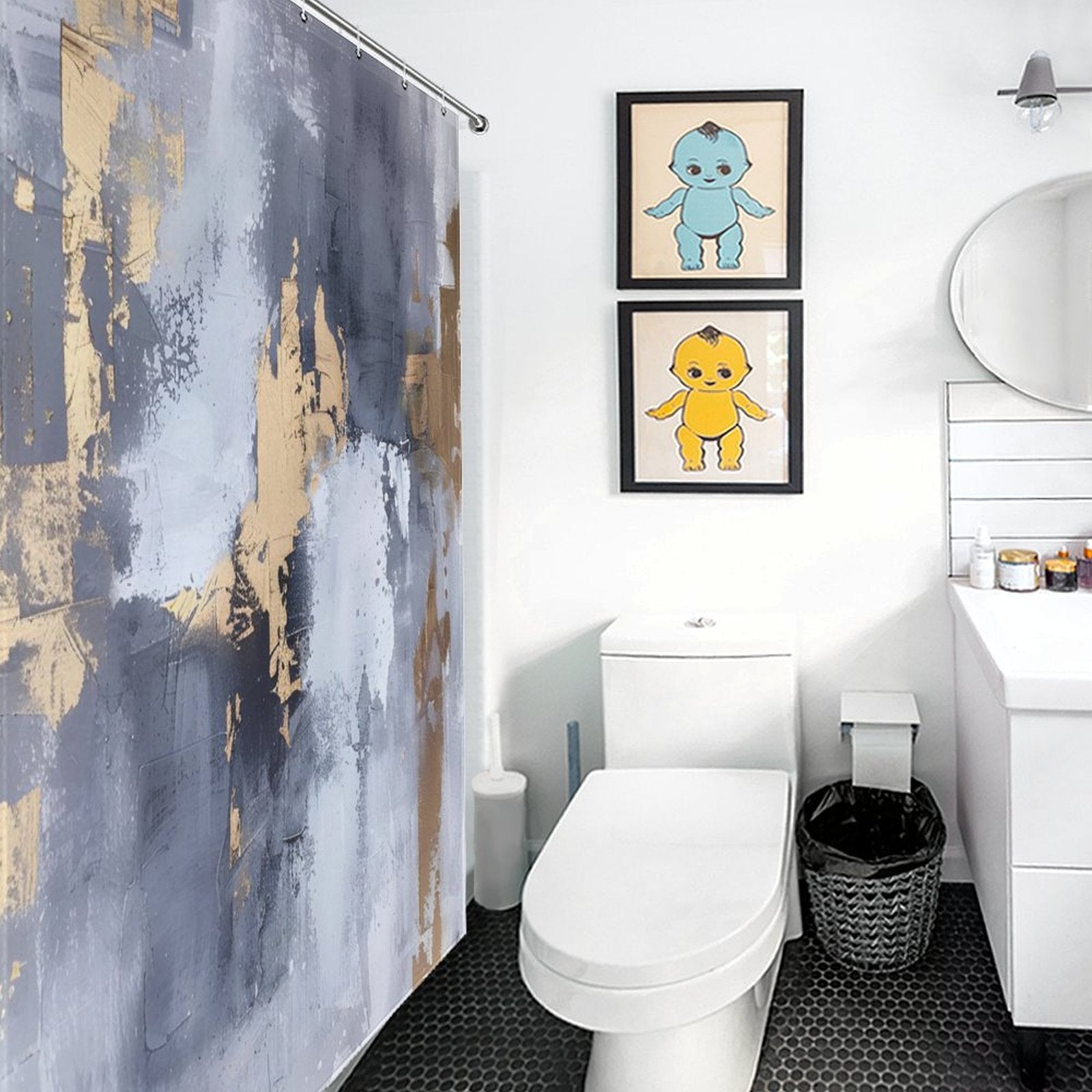 Contemporary bathroom with a white toilet, sink, round mirror, and Grey and Gold Watercolor Abstract Modern Art White Silver Strokes Shower Curtain-Cottoncat. Two framed baby-themed artworks hang on the wall above the toilet. Black hexagonal floor tiles add contrast to the space.