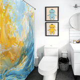 A bathroom with a toilet, sink, and mirror. It features an Abstract Yellow and Blue Wave Ocean Watercolor Shower Curtain-Cottoncat by Cotton Cat, and two framed pictures of cartoon characters on the wall.