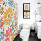 A bathroom with a white toilet, sink, and a Boho Colorful Yellow Flower Leaves Minimalist Watercolor Art Painting Floral Shower Curtain-Cottoncat. Above the toilet are two framed illustrations of cartoon characters. A circular mirror hangs on the wall, adding to the charming bathroom decor.