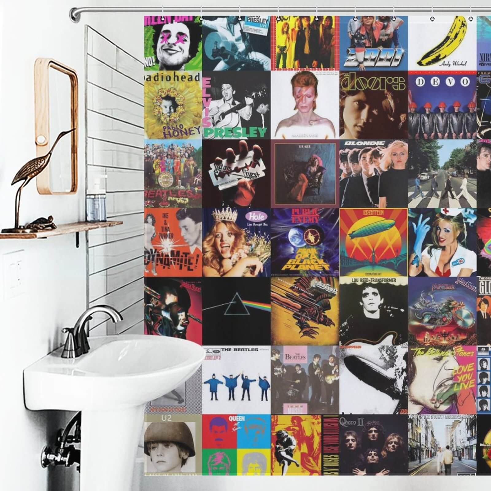 A bathroom with album covers on the wall, perfect for music enthusiasts, featuring the Music Album Shower Curtain by Cotton Cat.
