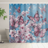 Introducing the Vintage Pink Butterfly Flying over Water Shower Curtain by Cotton Cat, showcasing a vintage pink butterfly design fluttering delicately above water with cherry blossoms set against a serene blue background. Made from water-resistant fabric, it pairs beautifully with a potted plant beside your white bathtub.