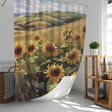 The Cotton Cat Rustic Sunflowers Grasses Gentle Hills Shower Curtain, showcasing a field of sunflowers with rolling hills and a blue sky in the background, hangs beautifully in a white bathroom adorned with a wicker basket and wooden shelf. This sunflower-themed design adds charming decor to your bathroom.