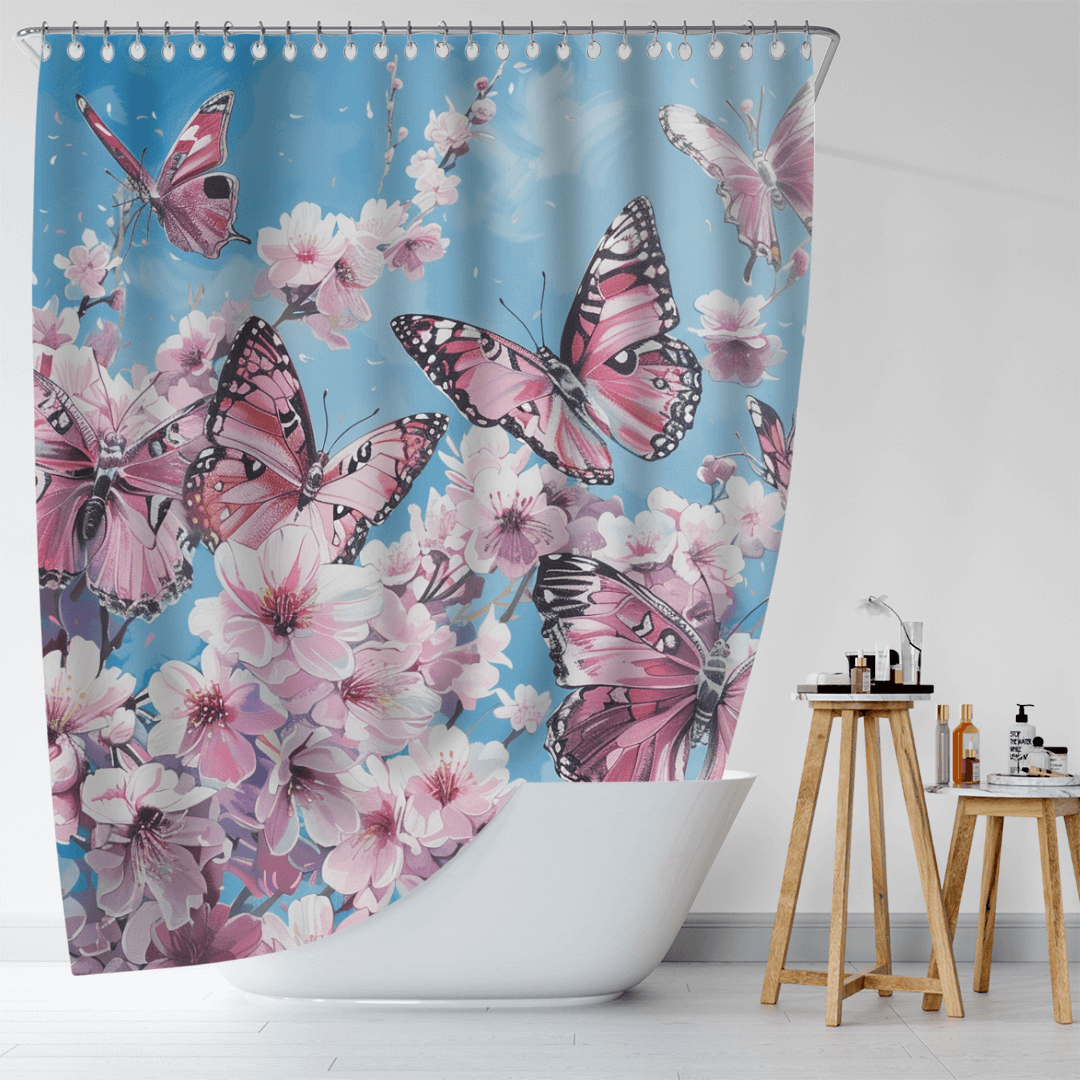 A white bathtub adorned with a Cotton Cat Vintage Pink Butterfly Flying over Water Shower Curtain, showcasing cherry blossoms against a blue background. A wooden stand with toiletries sits next to the tub, enhancing the charming vintage bathroom decor.